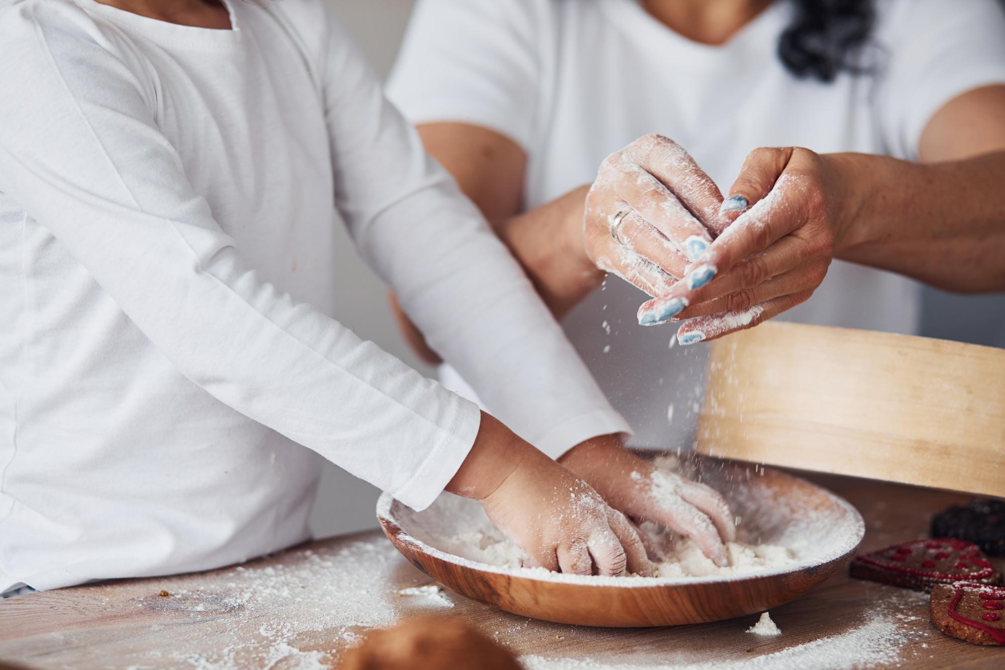 Hands kneading dough at workshop